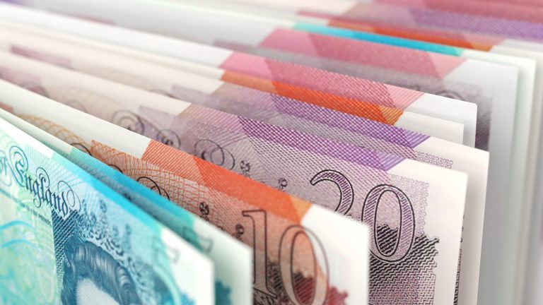 Fanned stack of British pound banknotes in various denominations